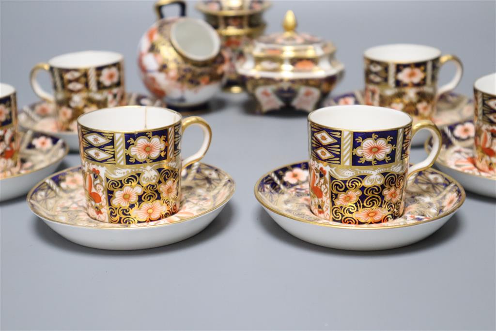 A Royal Crown Derby part tea service, pattern no. 2451, a similar vase and a sugar scuttle (faults)